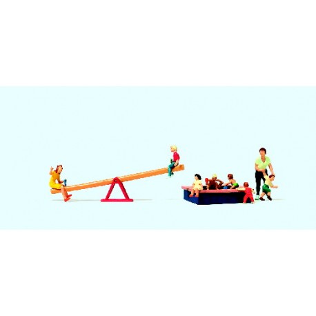 Children play with seesaw and sandpit. PREISER 10587